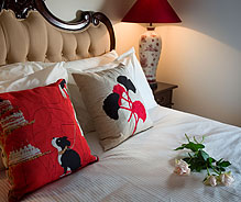 Australis Suite close up of bed with lamp and roses